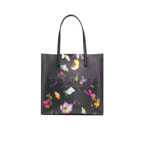 Black tote bag with colorful floral pattern and Ted Baker logo on a white background